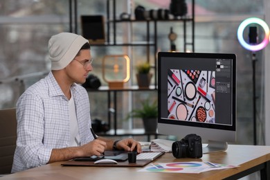 Photo of Professional retoucher working on computer in office