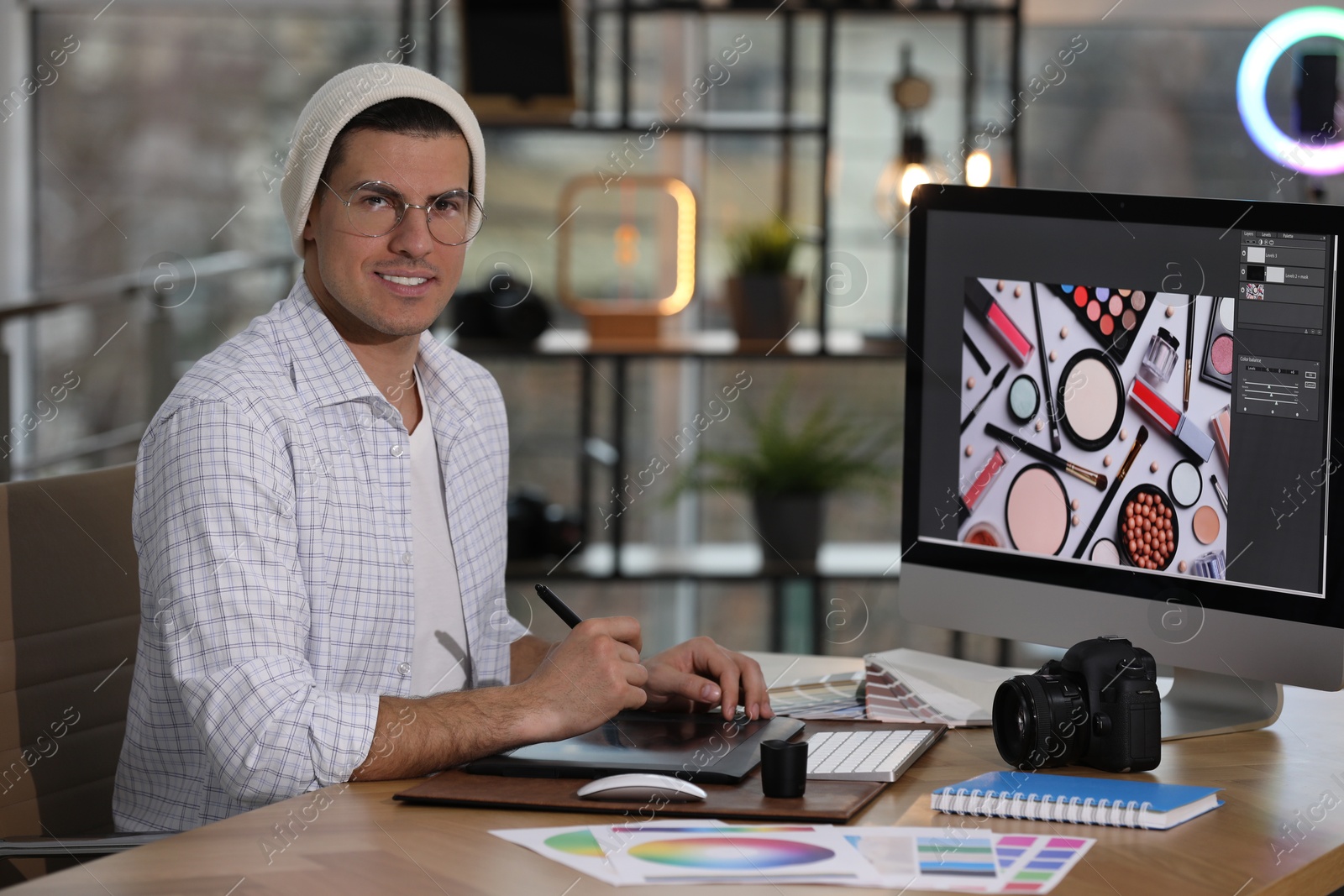 Photo of Professional retoucher working on computer in office