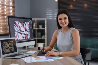 Professional retoucher working on computer in office