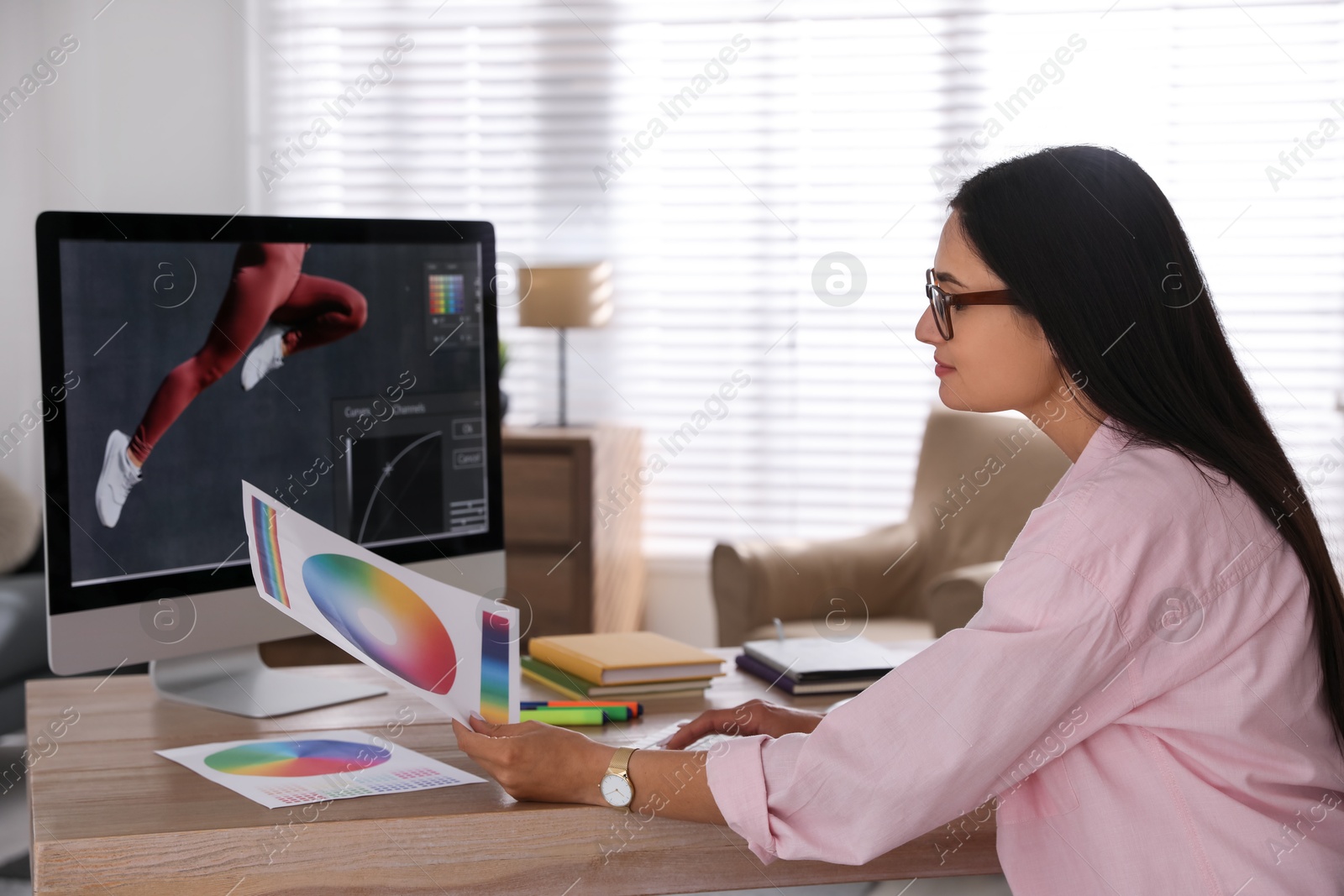 Photo of Professional retoucher working on computer in office