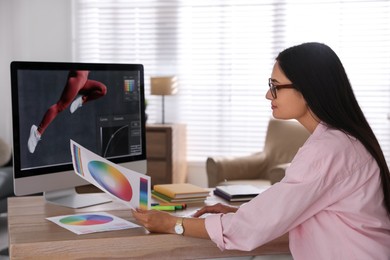 Professional retoucher working on computer in office