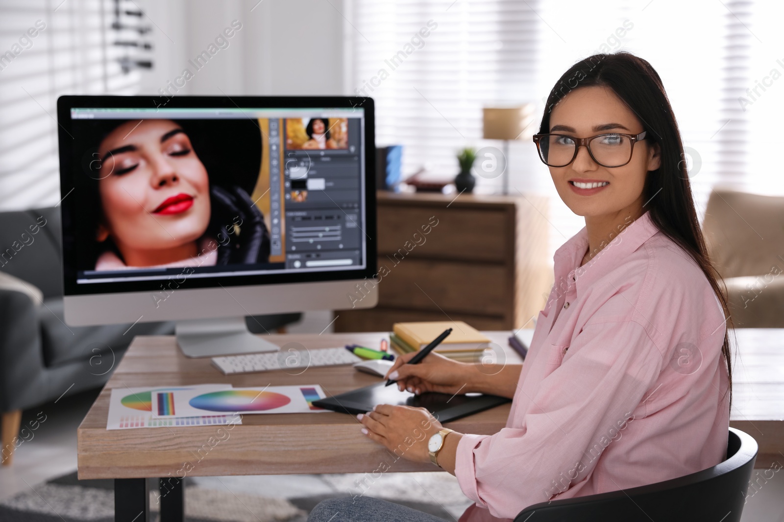 Photo of Professional retoucher working on computer in office