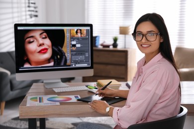 Professional retoucher working on computer in office