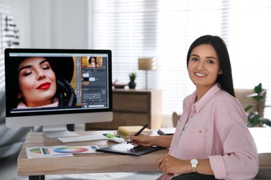 Professional retoucher working on computer in office