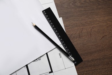 Photo of Different architectural drawings, pencil and ruler on wooden table, top view