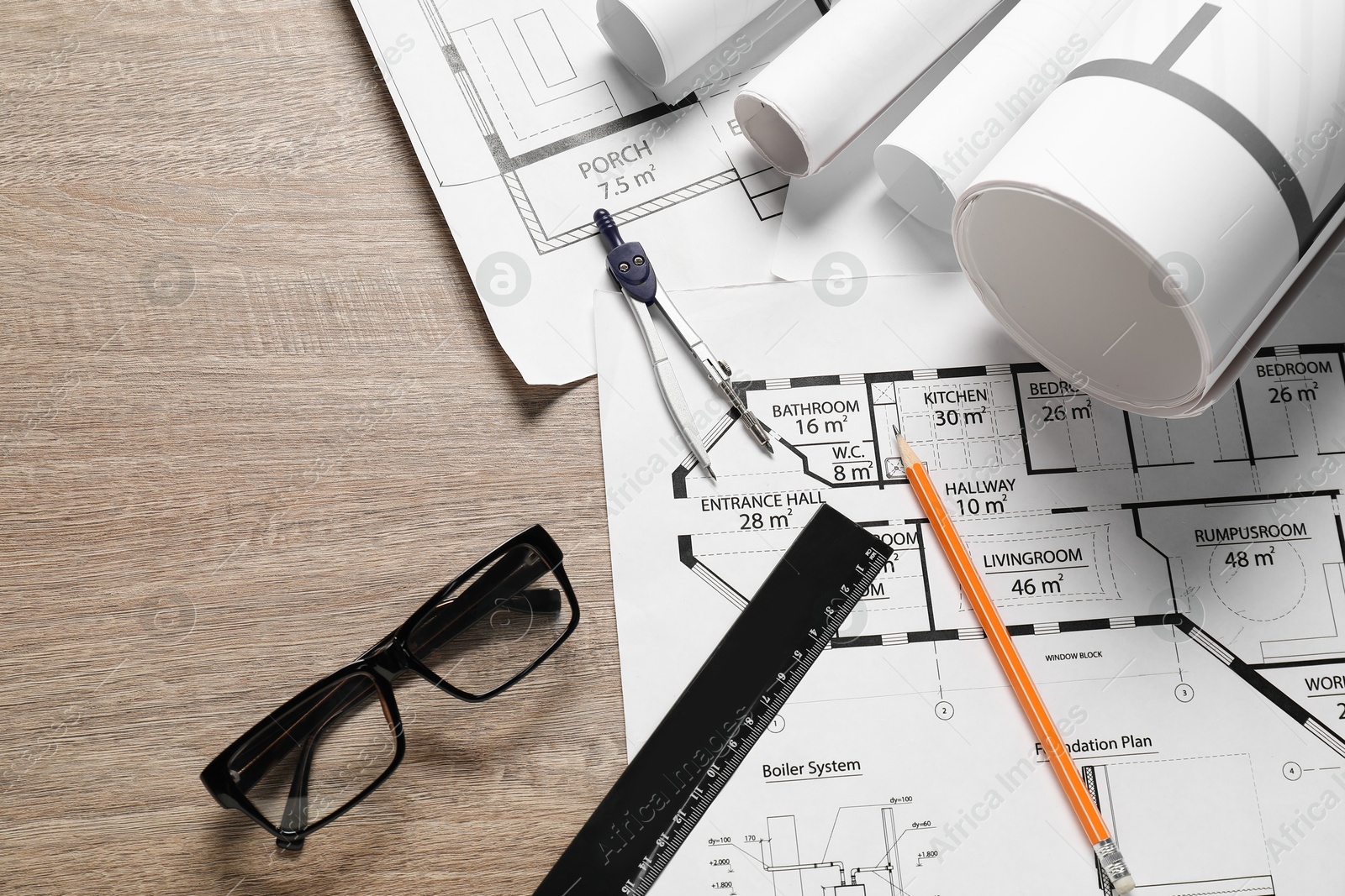 Photo of Different engineering drawings, glasses, ruler, pencil and dividers on wooden table