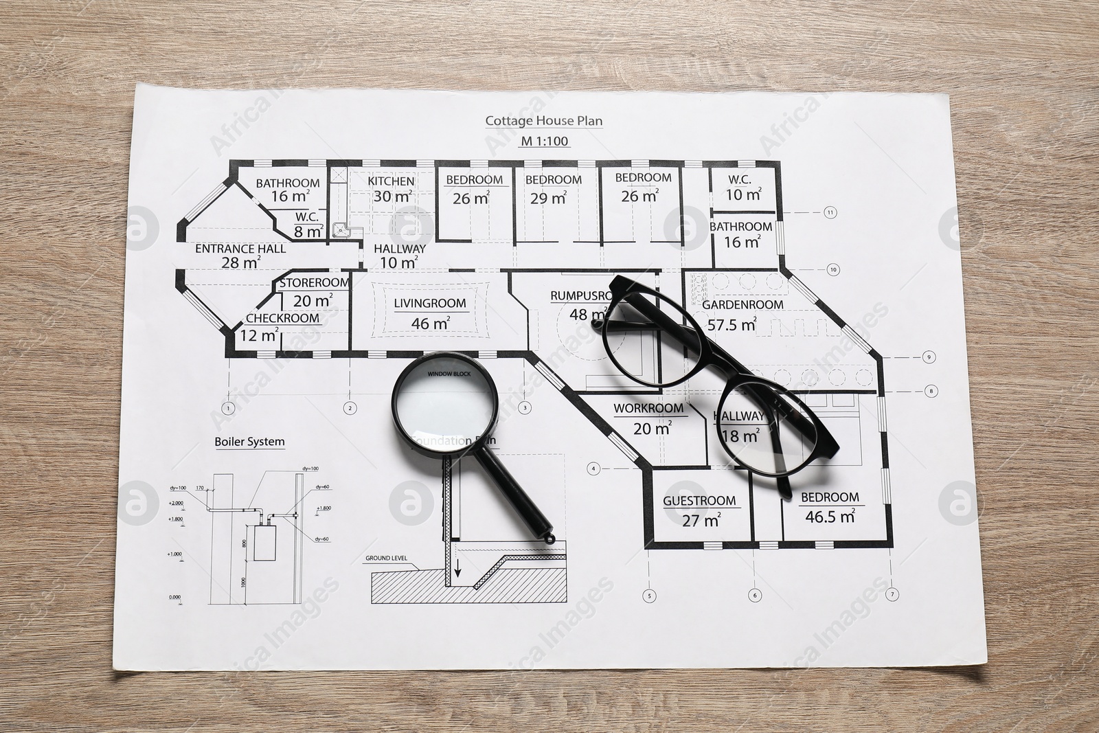 Photo of Different engineering drawings, glasses and magnifying glass on wooden table, top view