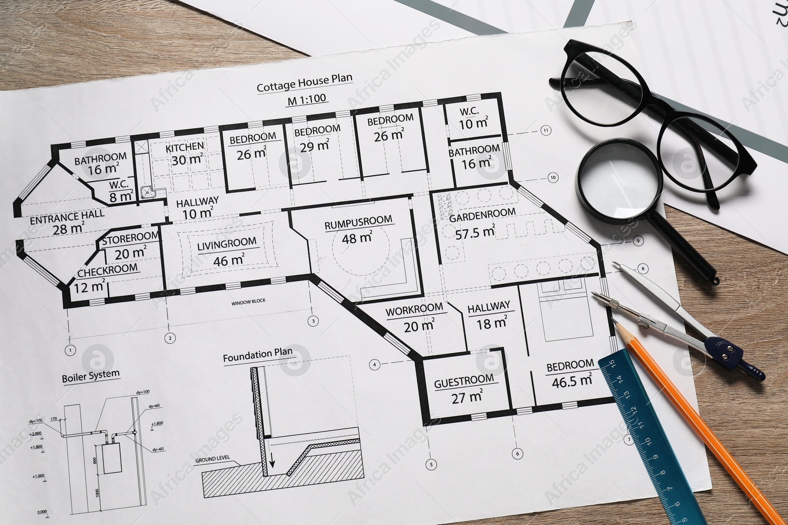 Photo of Different engineering drawings, pencil, dividers, ruler, glasses and magnifying glass on wooden table, flat lay