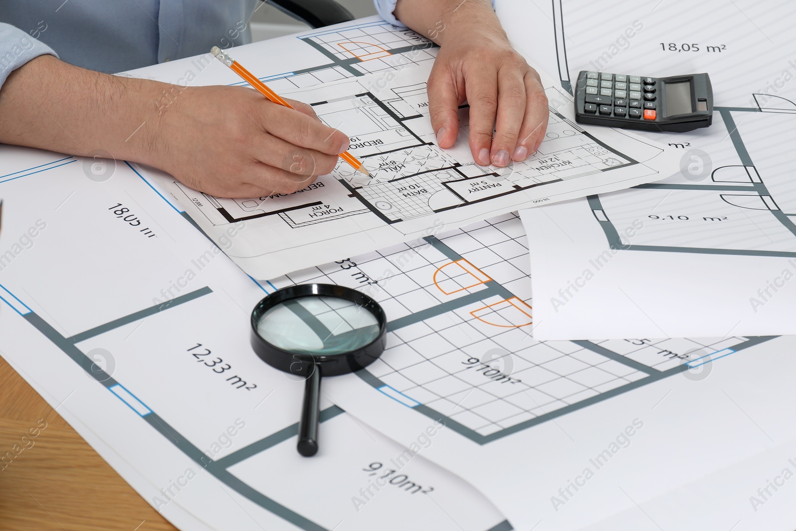 Photo of Architect working with project at table in office, closeup