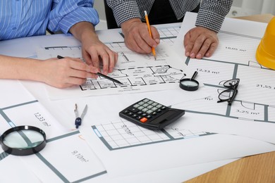 Photo of Architects working with project at table in office, closeup