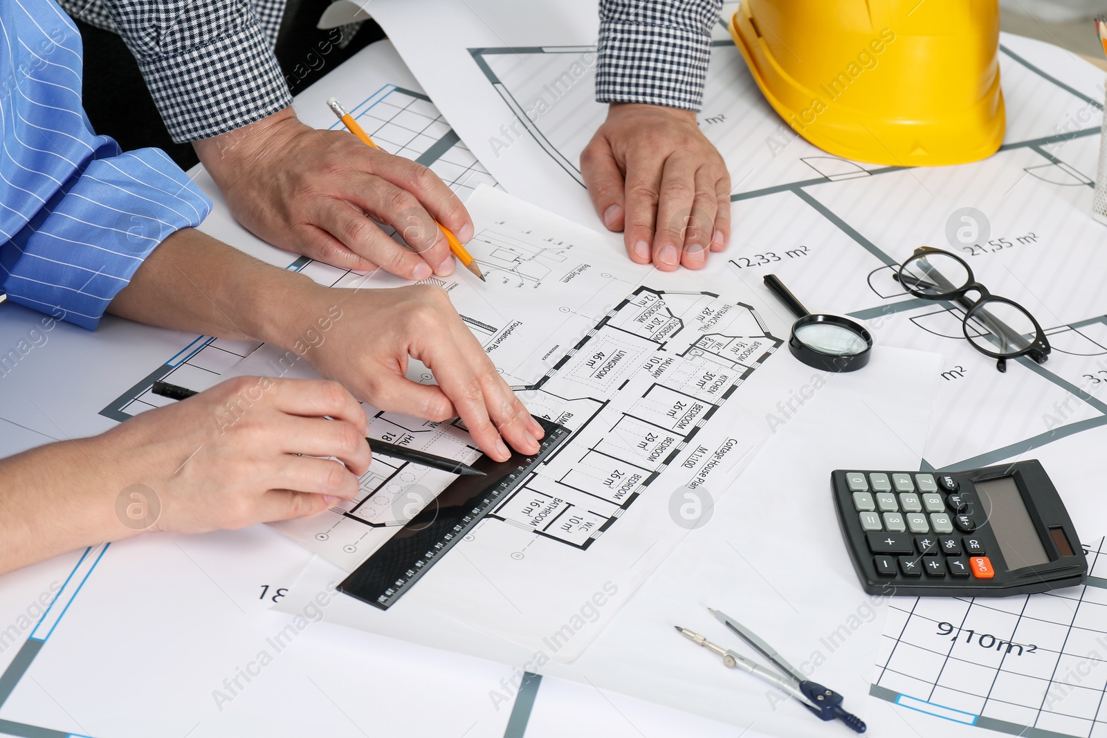 Photo of Architects working with project at table in office, closeup