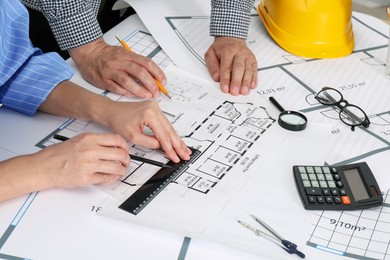 Architects working with project at table in office, closeup