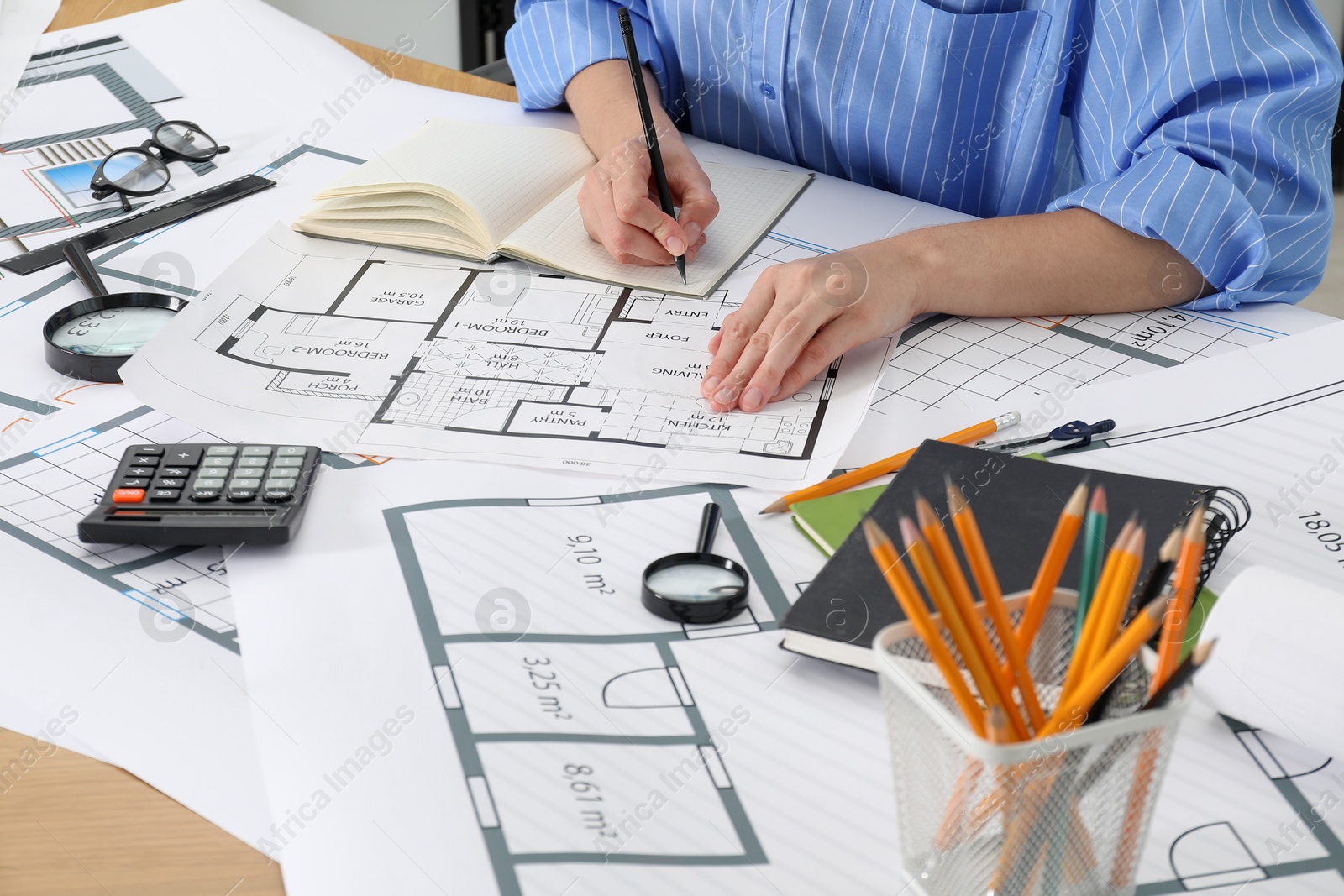 Photo of Architect working with project at table in office, closeup