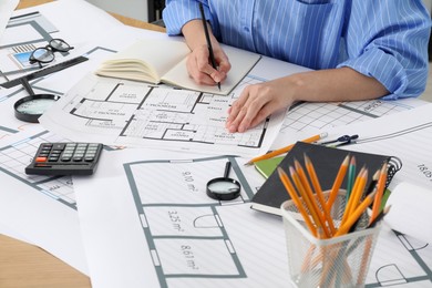 Photo of Architect working with project at table in office, closeup