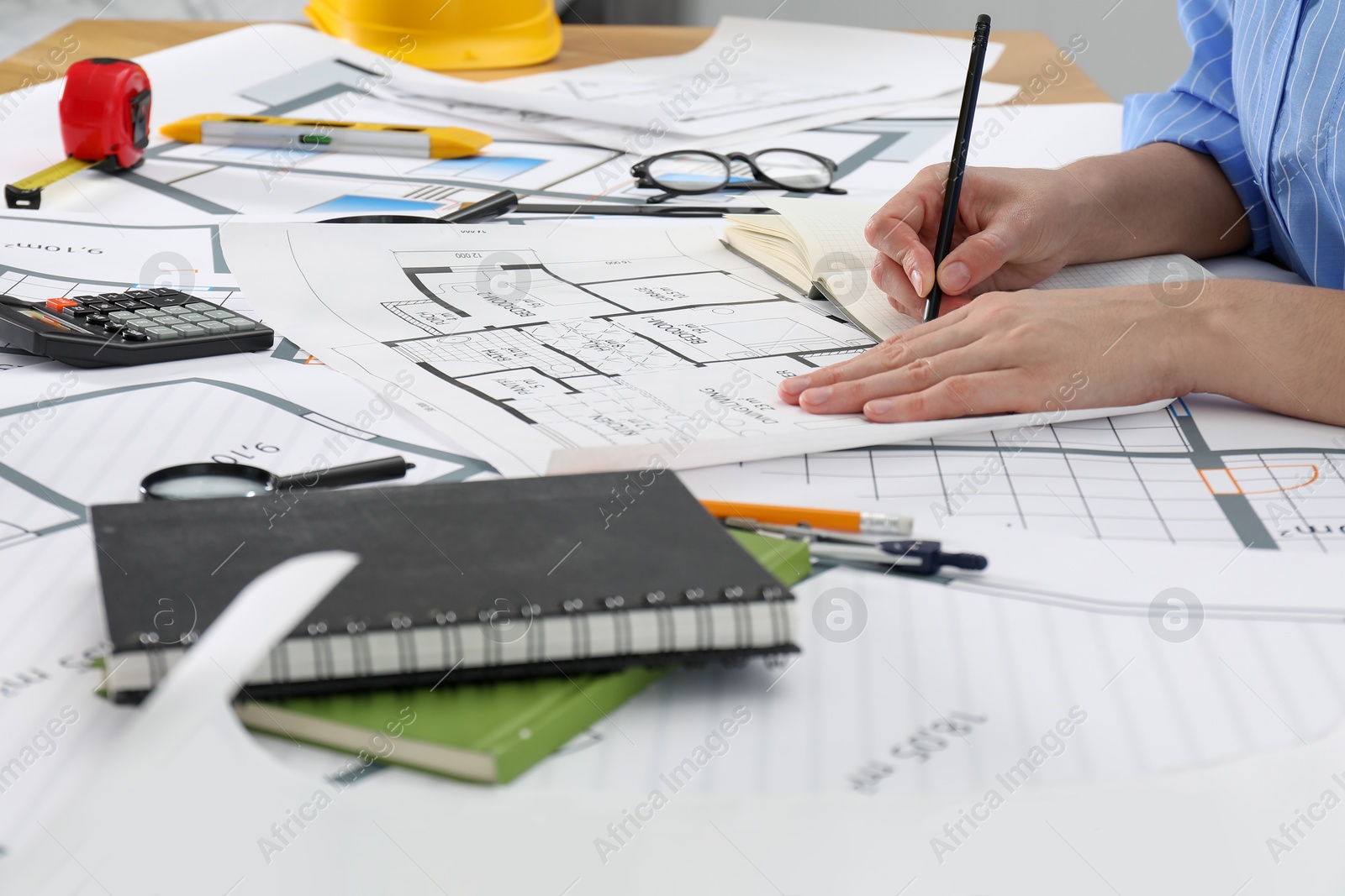 Photo of Architect working with project at table in office, closeup