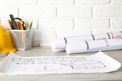 Different engineering drawings and tools on wooden table