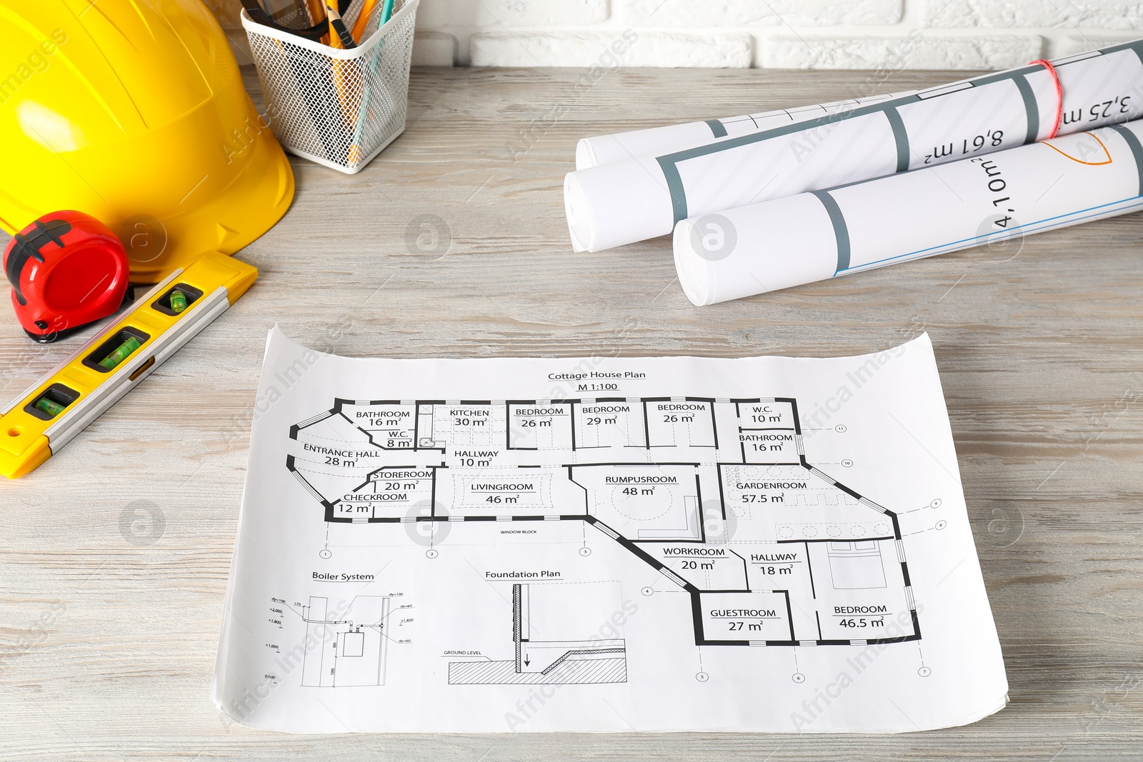 Photo of Different engineering drawings and tools on wooden table