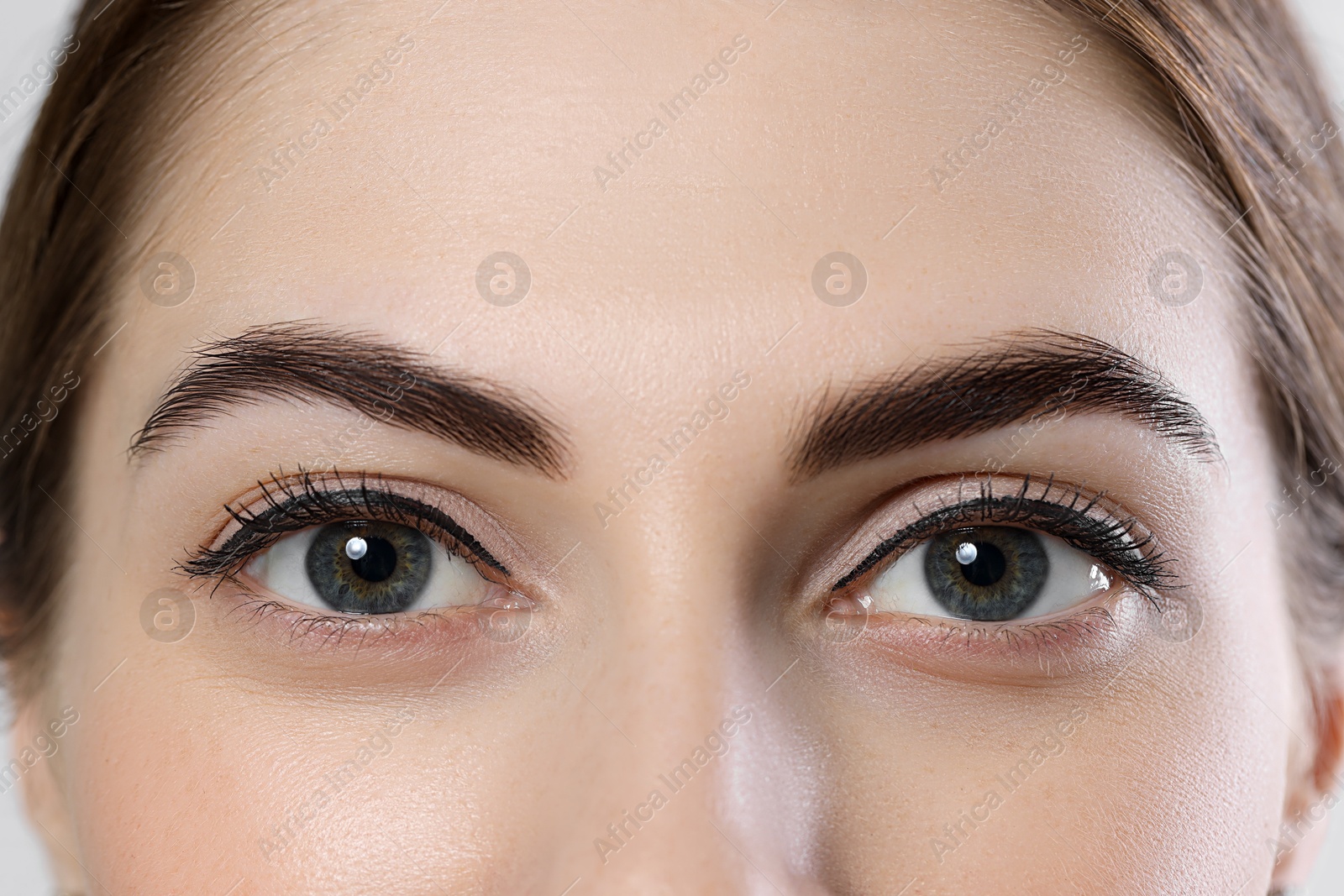 Photo of Beautiful young woman after henna eyebrows dyeing, closeup