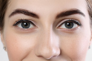 Photo of Beautiful young woman after henna eyebrows dyeing, closeup