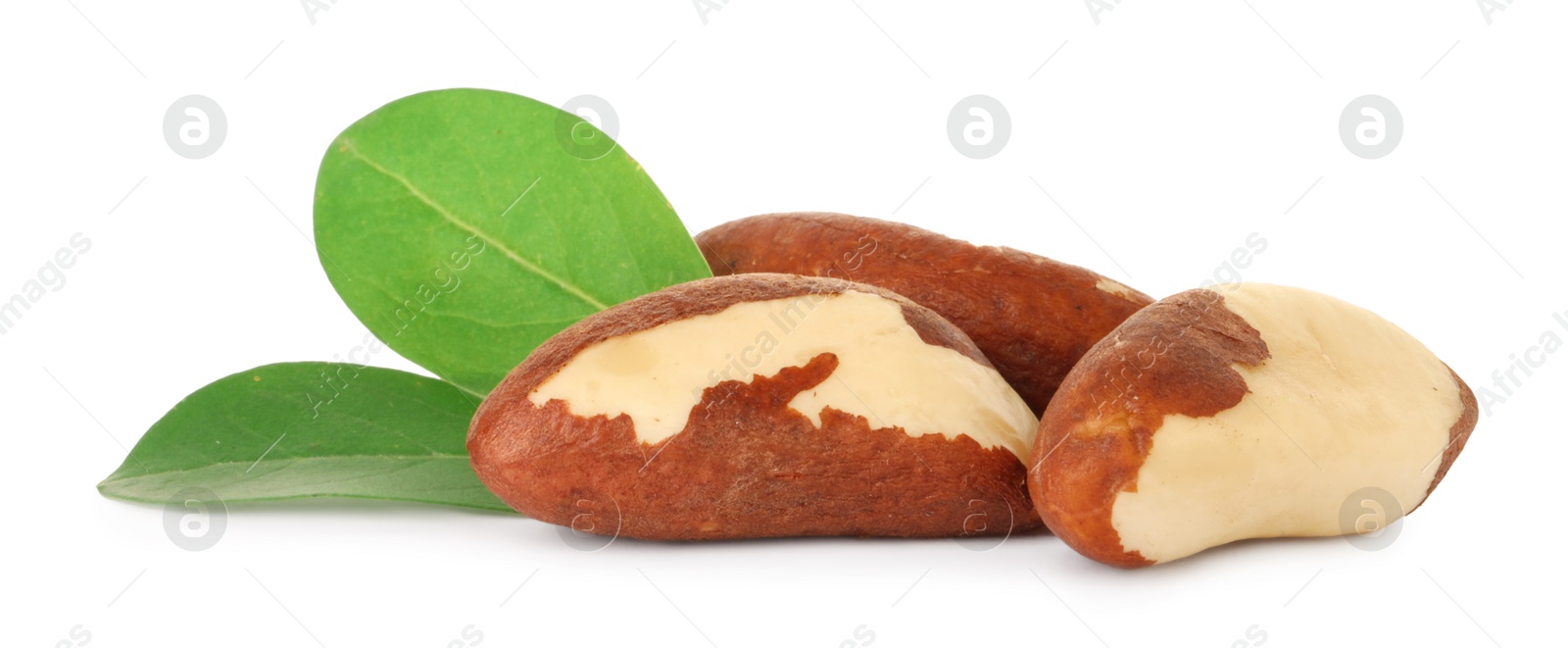 Photo of Tasty Brazil nuts with green leaves isolated on white