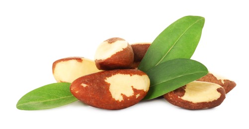 Photo of Tasty Brazil nuts with green leaves isolated on white