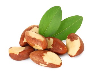 Photo of Tasty Brazil nuts with green leaves isolated on white