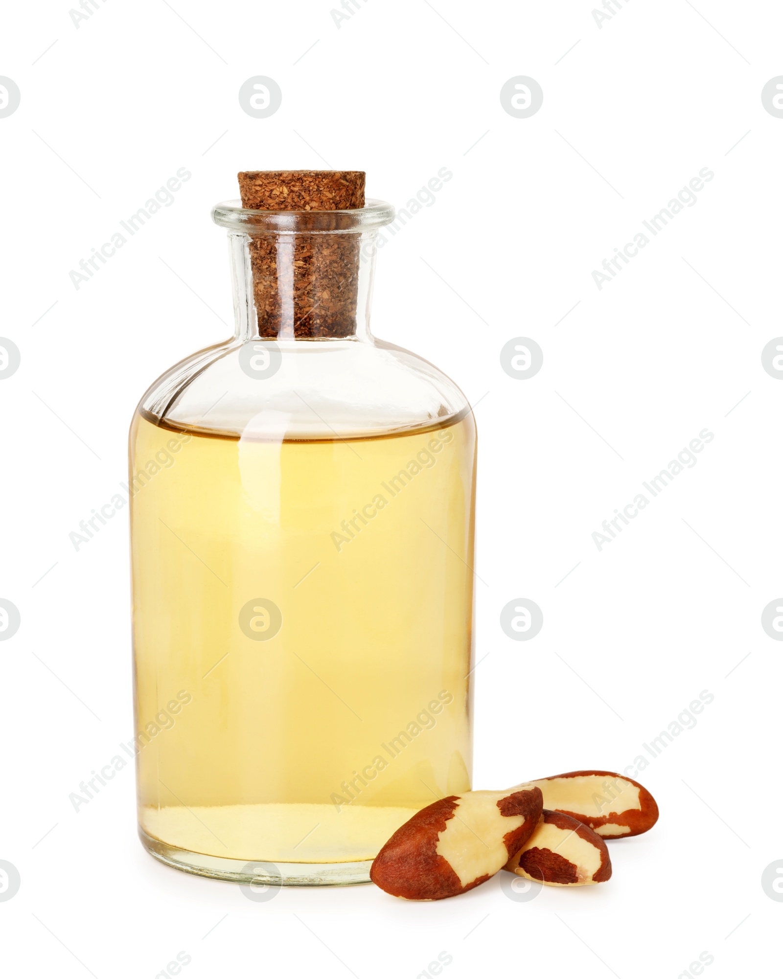 Photo of Tasty Brazil nuts and bottle with oil isolated on white