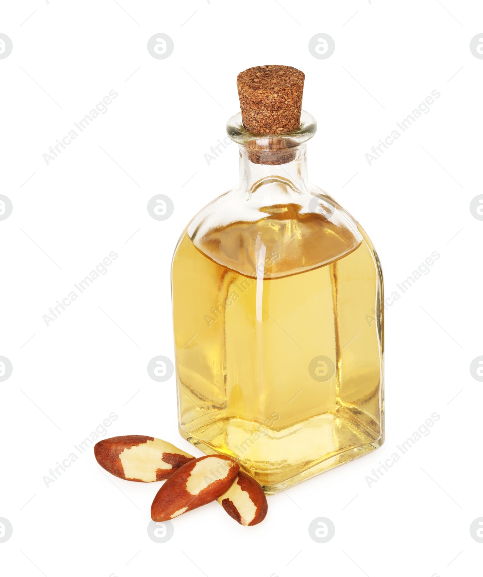 Photo of Tasty Brazil nuts and bottle with oil isolated on white