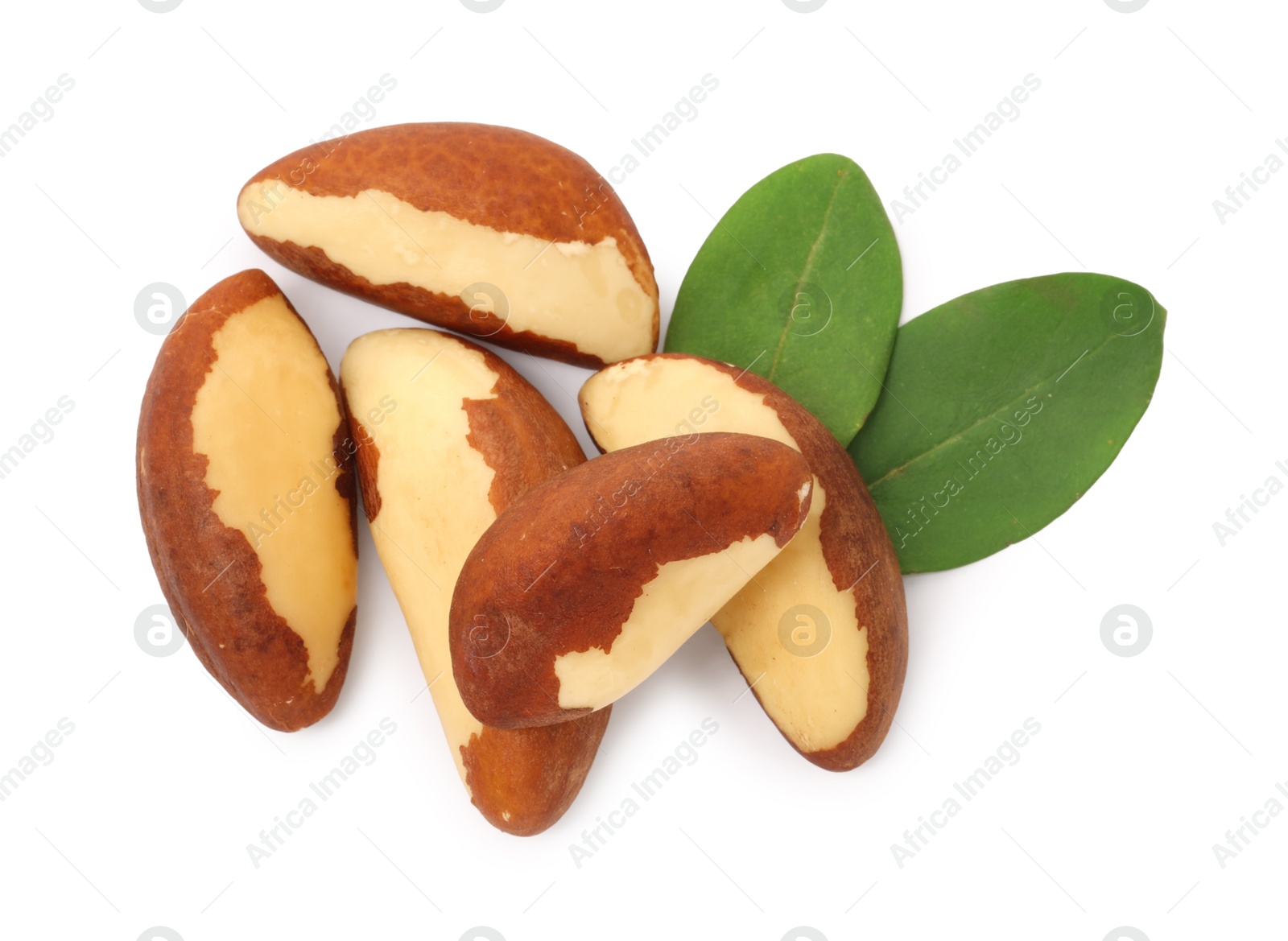 Photo of Tasty Brazil nuts and green leaves isolated on white, top view