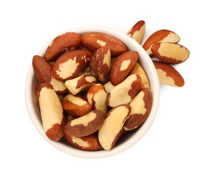 Photo of Tasty Brazil nuts in bowl isolated on white, top view