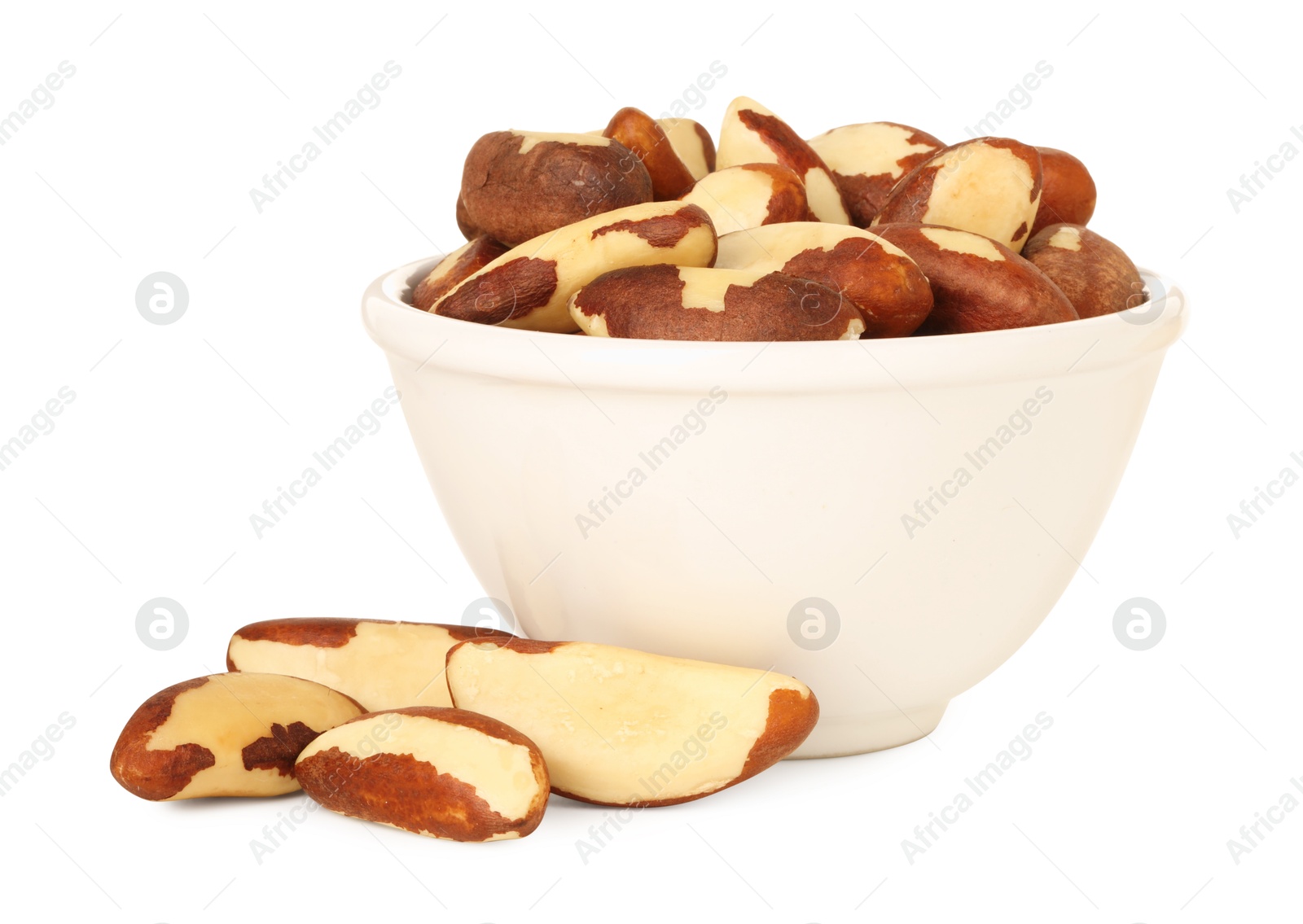 Photo of Tasty Brazil nuts in bowl isolated on white