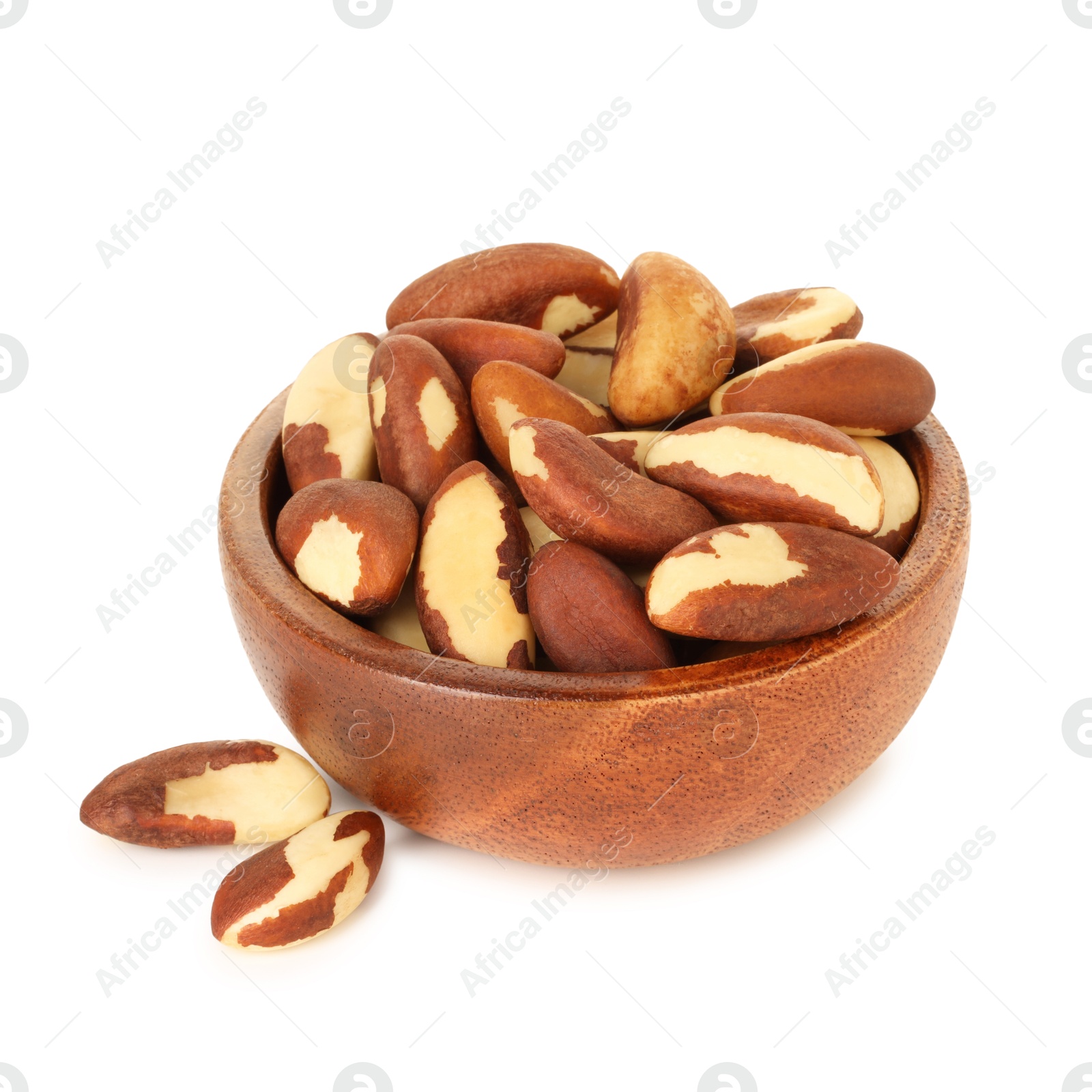 Photo of Tasty Brazil nuts in bowl isolated on white