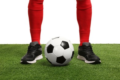 Photo of Football player with soccer ball on artificial grass against white background, closeup