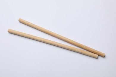 Photo of Two bamboo drinking straws on white background