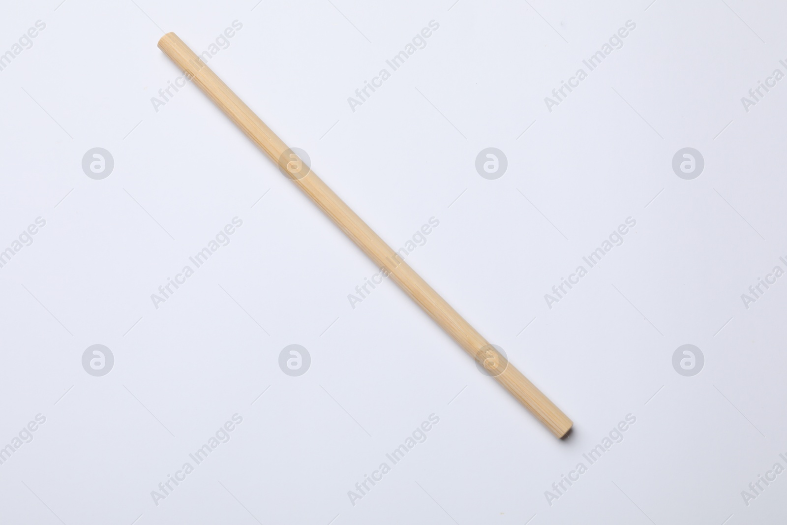 Photo of One bamboo drinking straw on white background, top view