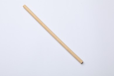 Photo of One bamboo drinking straw on white background, top view