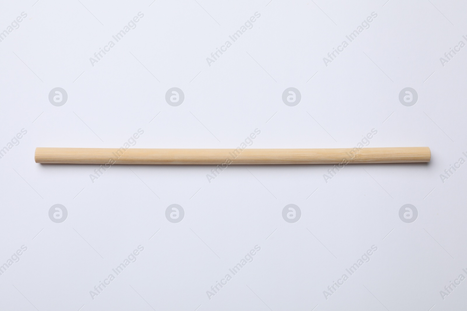 Photo of One bamboo drinking straw on white background, above view