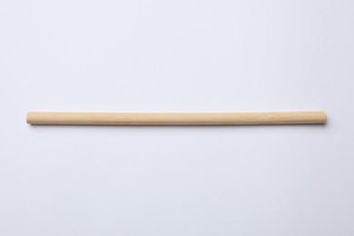 Photo of One bamboo drinking straw on white background, above view