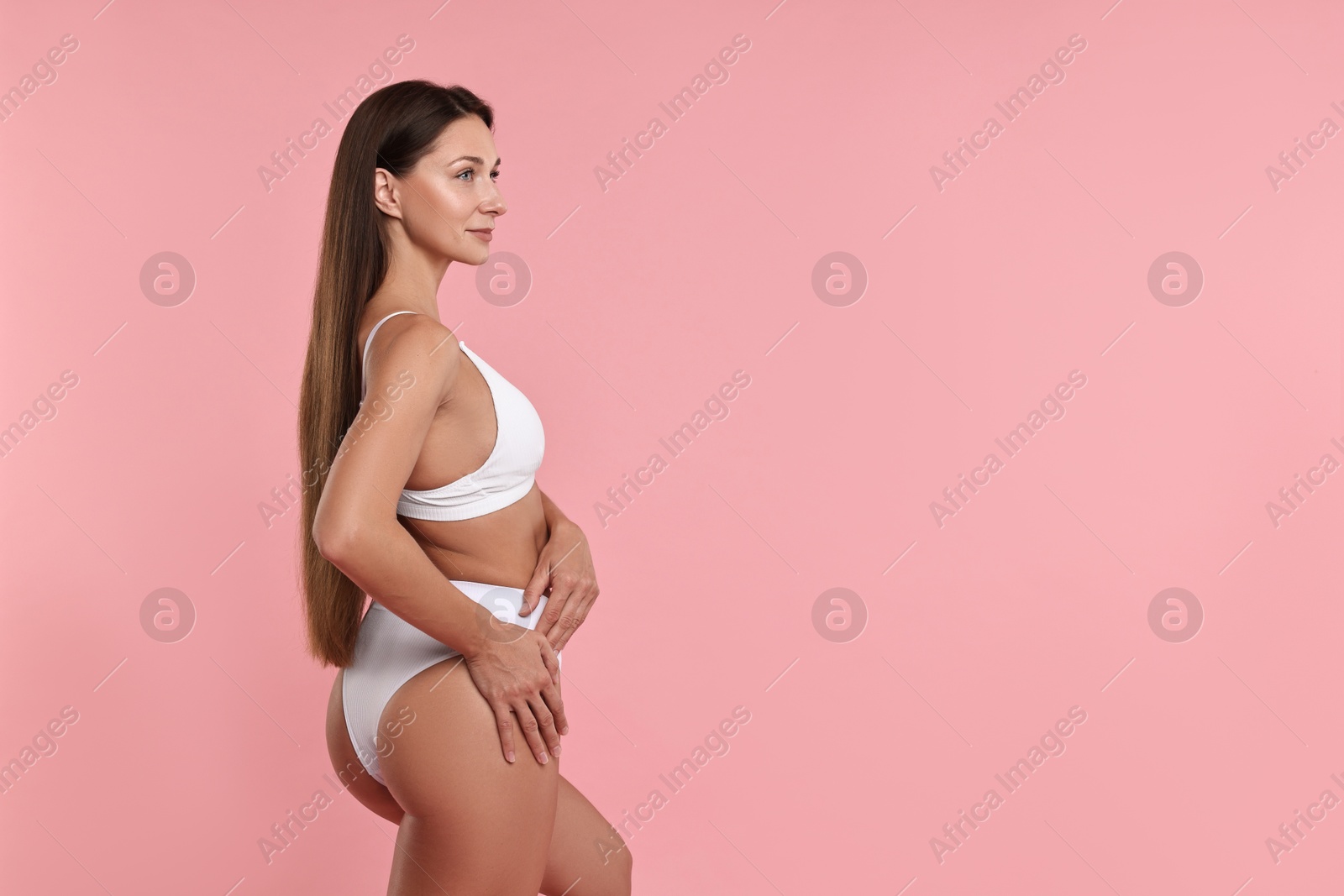 Photo of Beautiful woman with perfect skin on pink background, space for text. Body care