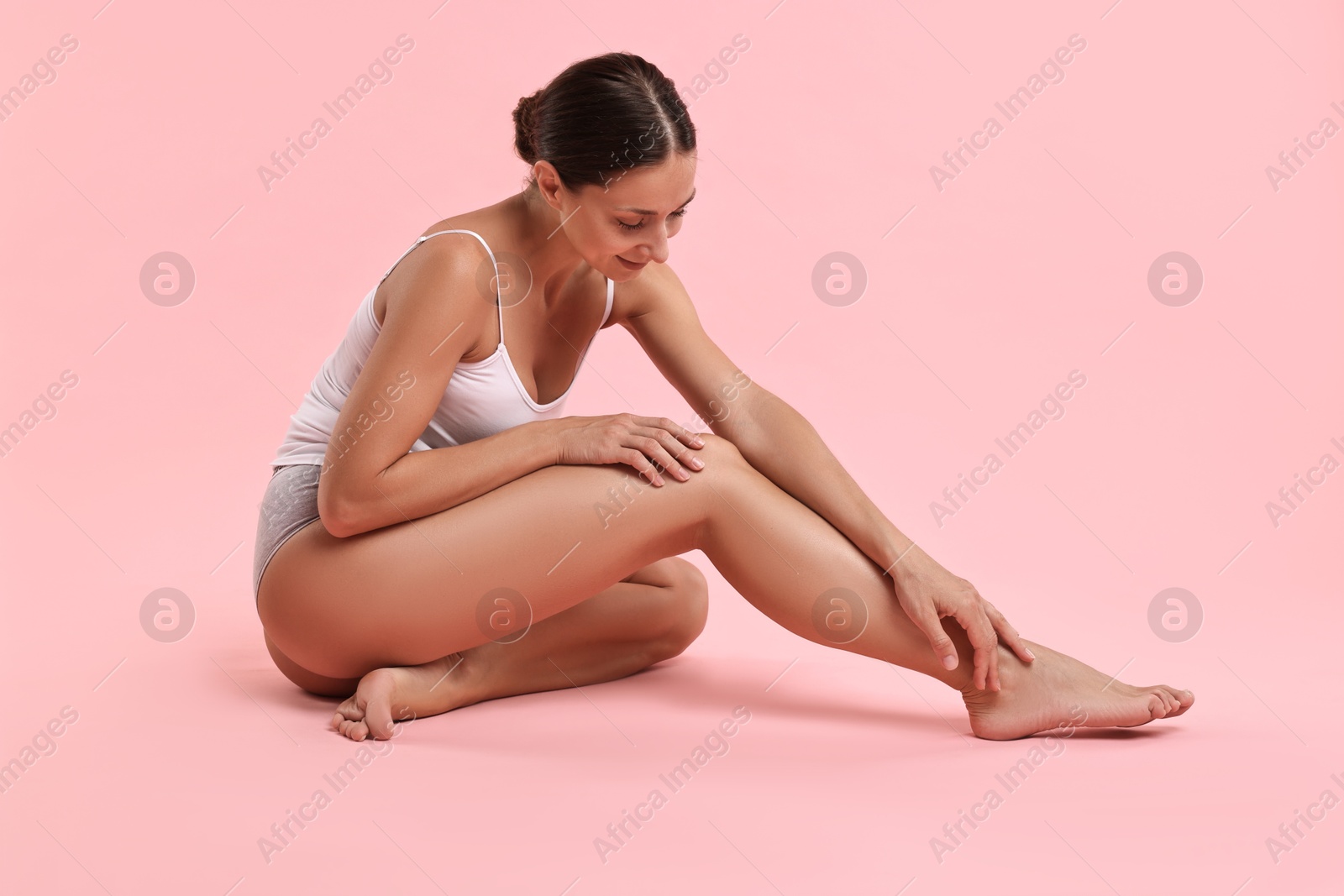 Photo of Beautiful woman with perfect skin posing on pink background. Body care