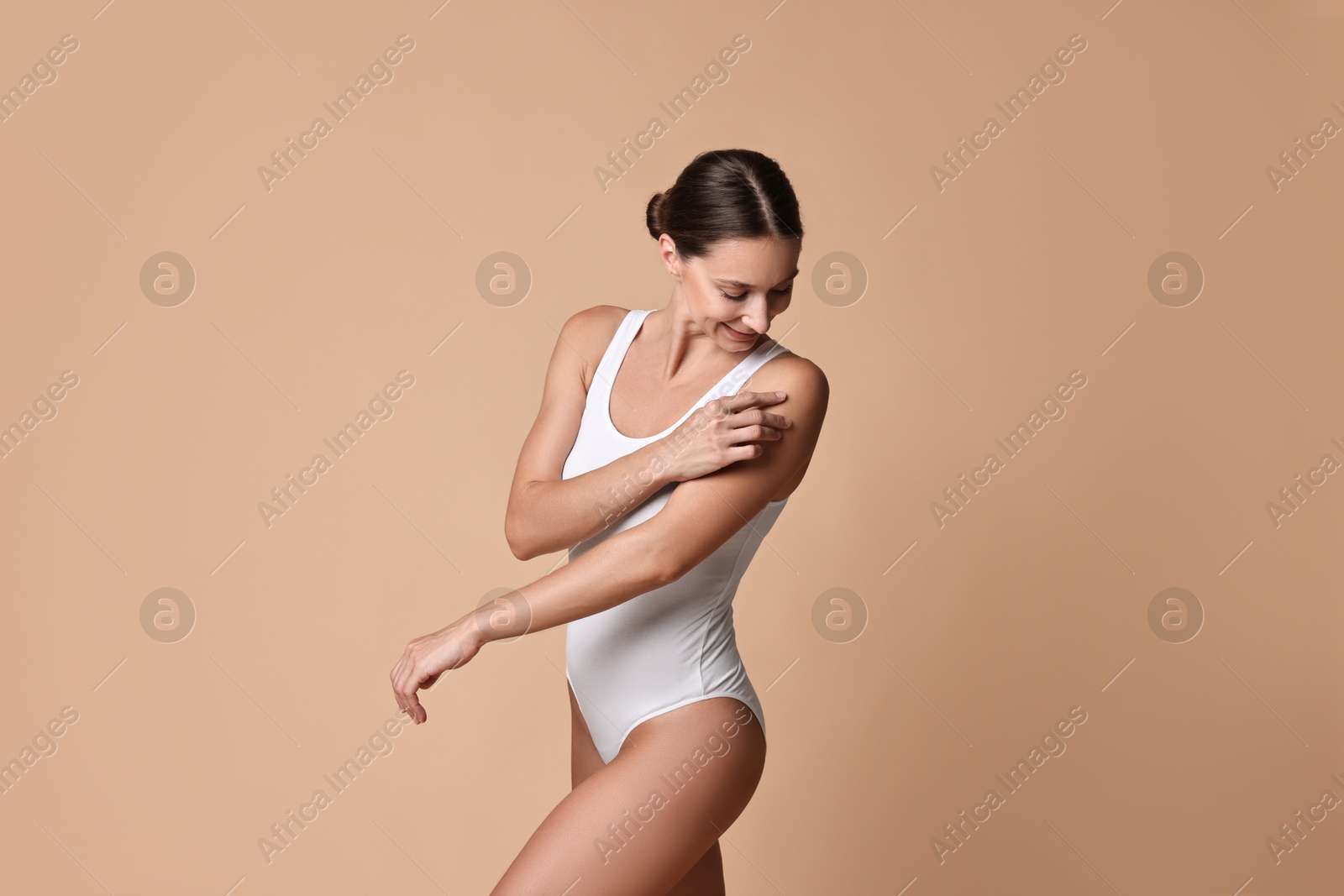 Photo of Beautiful woman with perfect skin on beige background. Body care