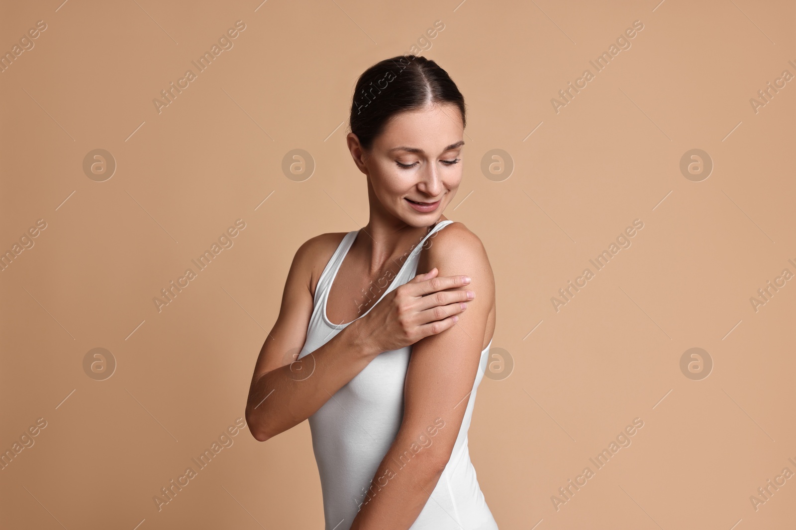 Photo of Beautiful woman with perfect skin on beige background. Body care