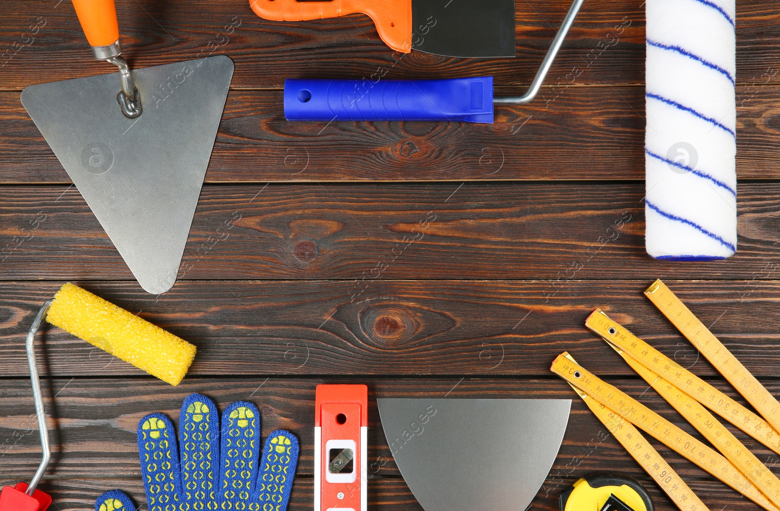 Photo of Different construction tools and rubber glove on wooden table, flat lay. Space for text