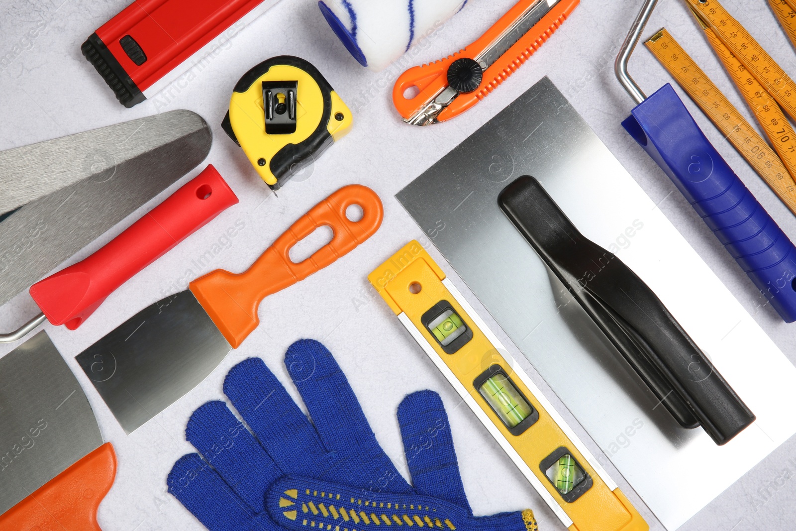 Photo of Flat lay composition with different construction tools on grey textured table