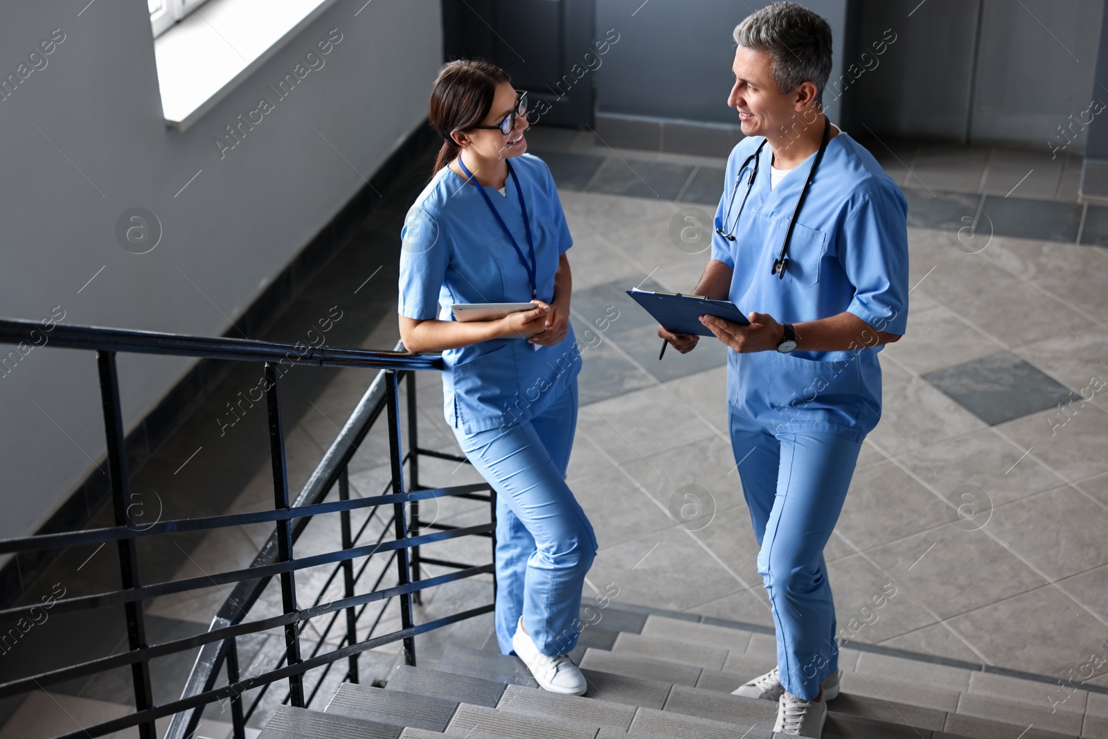 Photo of Healthcare workers talking on stairs in hospital