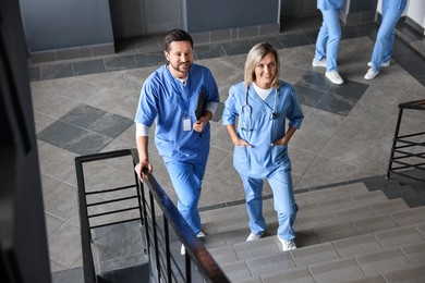 Healthcare workers walking up stairs in hospital