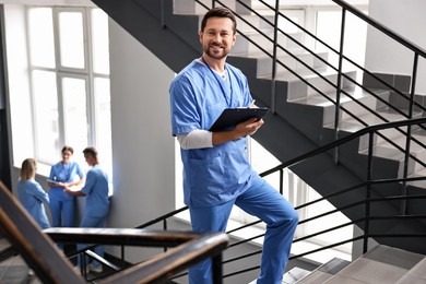 Healthcare workers in hospital, selective focus. Nurse with clipboard indoors