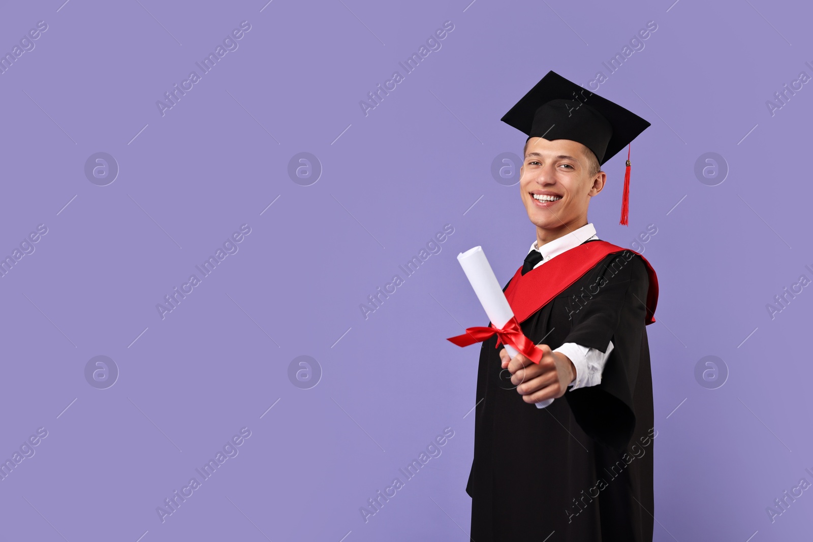 Photo of Happy student with diploma after graduation on violet background. Space for text