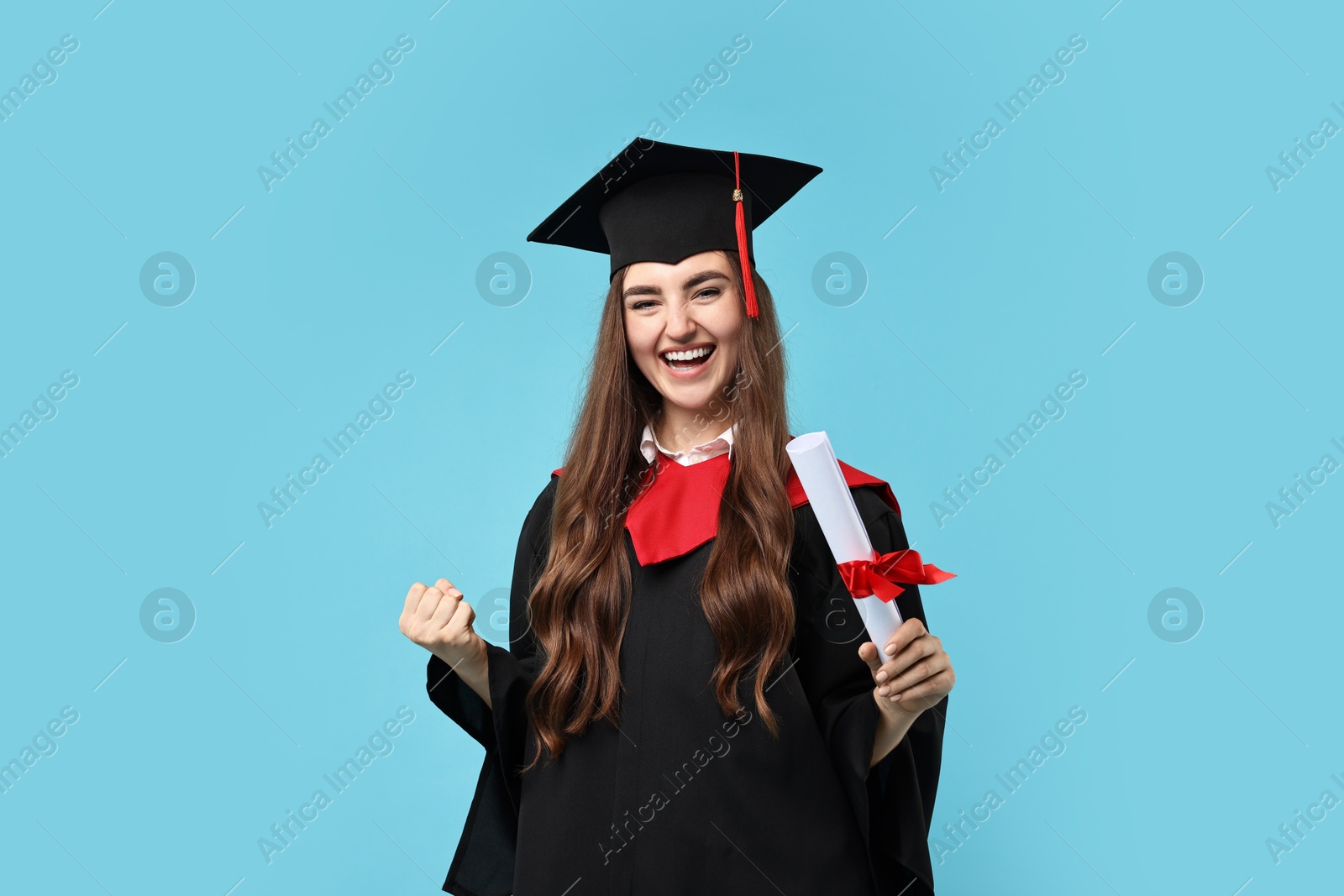 Photo of Happy student with diploma after graduation on light blue background