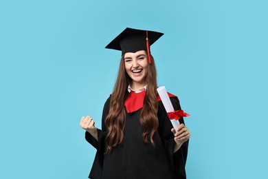 Photo of Happy student with diploma after graduation on light blue background